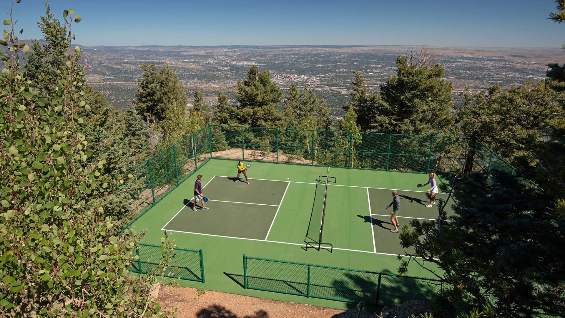 A Group Of People Playing Tennis