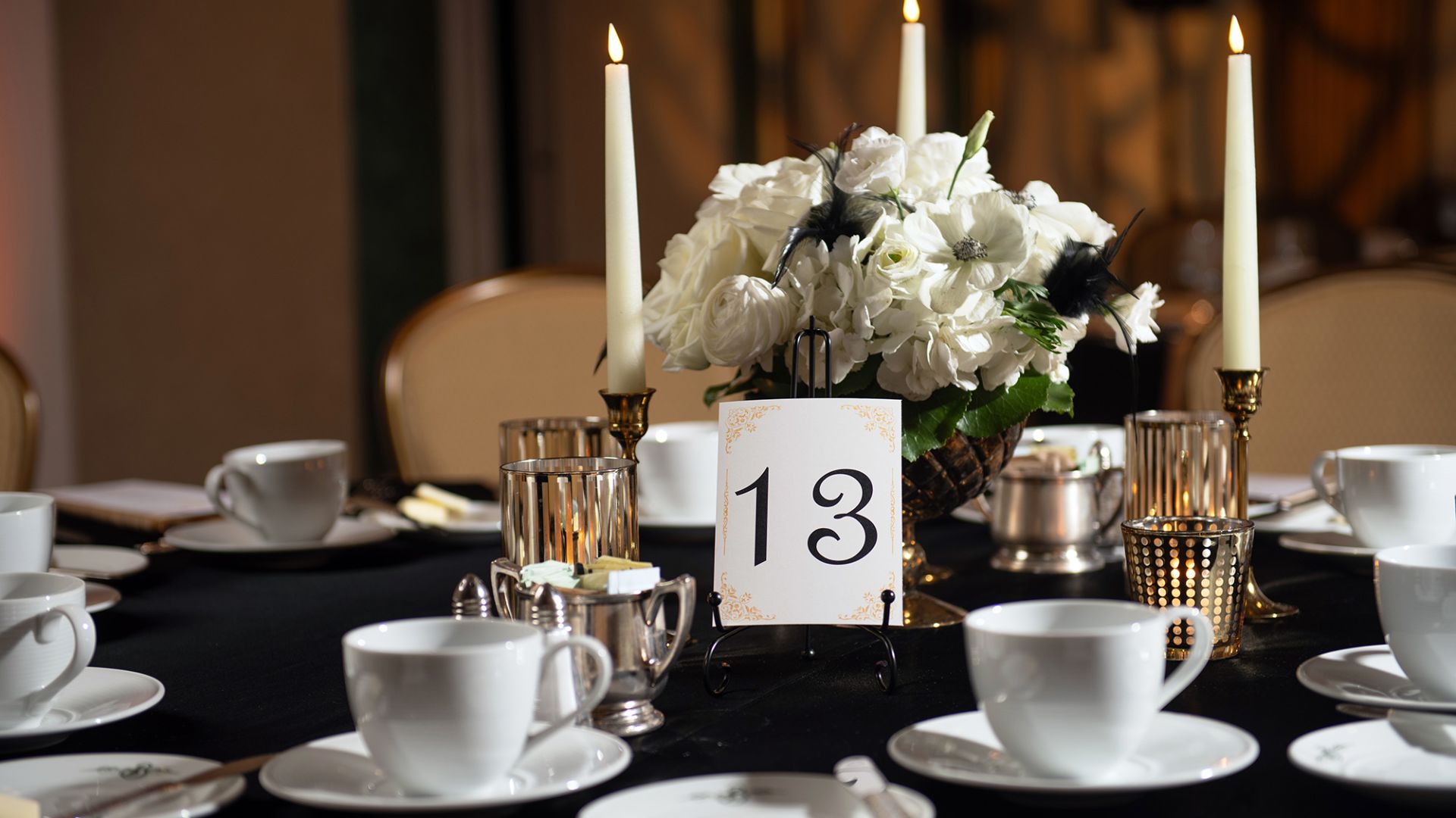 A Table With White Flowers And Candles