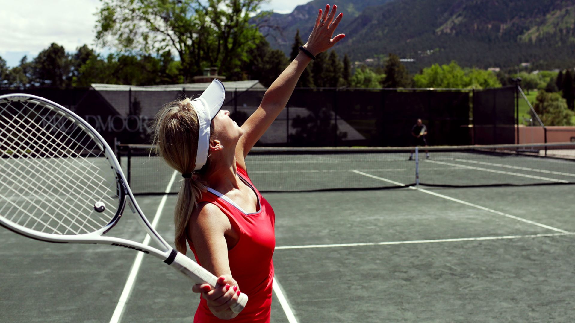 A Woman Holding A Racket On A Court