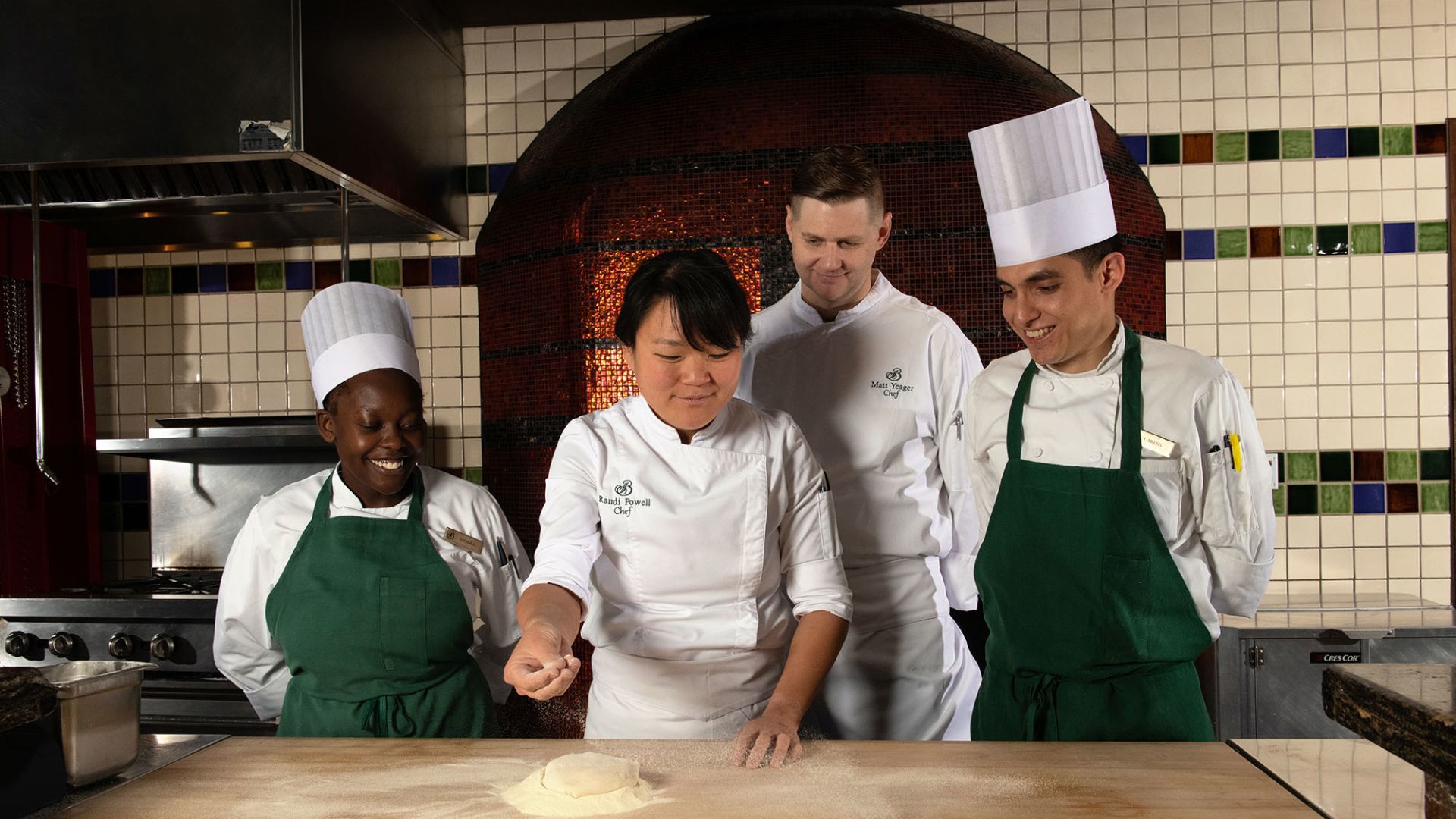 A Group Of Chefs In A Kitchen